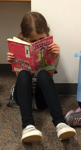 Milly-Reading-at-the-School-Library